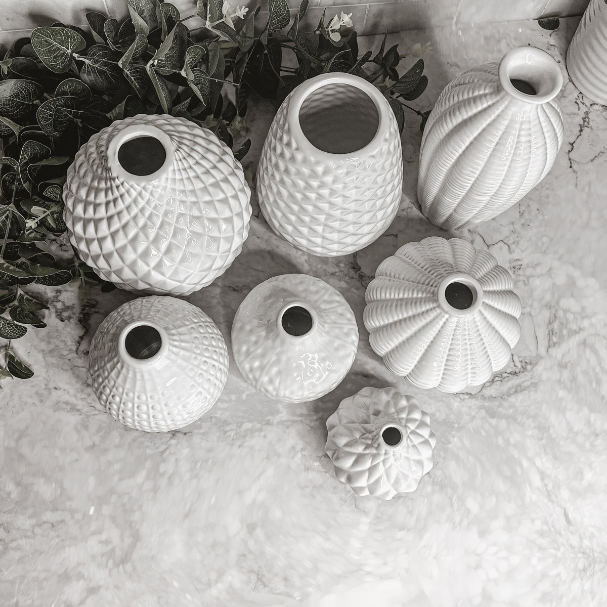 Elegant white ceramic Whitney Vases, artisan-made with exquisite detailing, perfect for flowers or home decor.