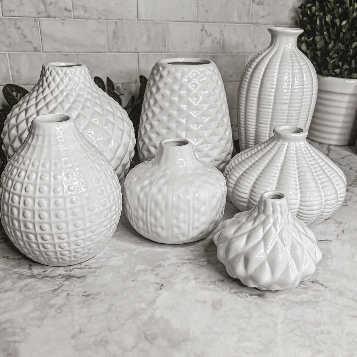 Elegant white ceramic Whitney Vases, artisan-made with exquisite detailing, perfect for flowers or home decor.