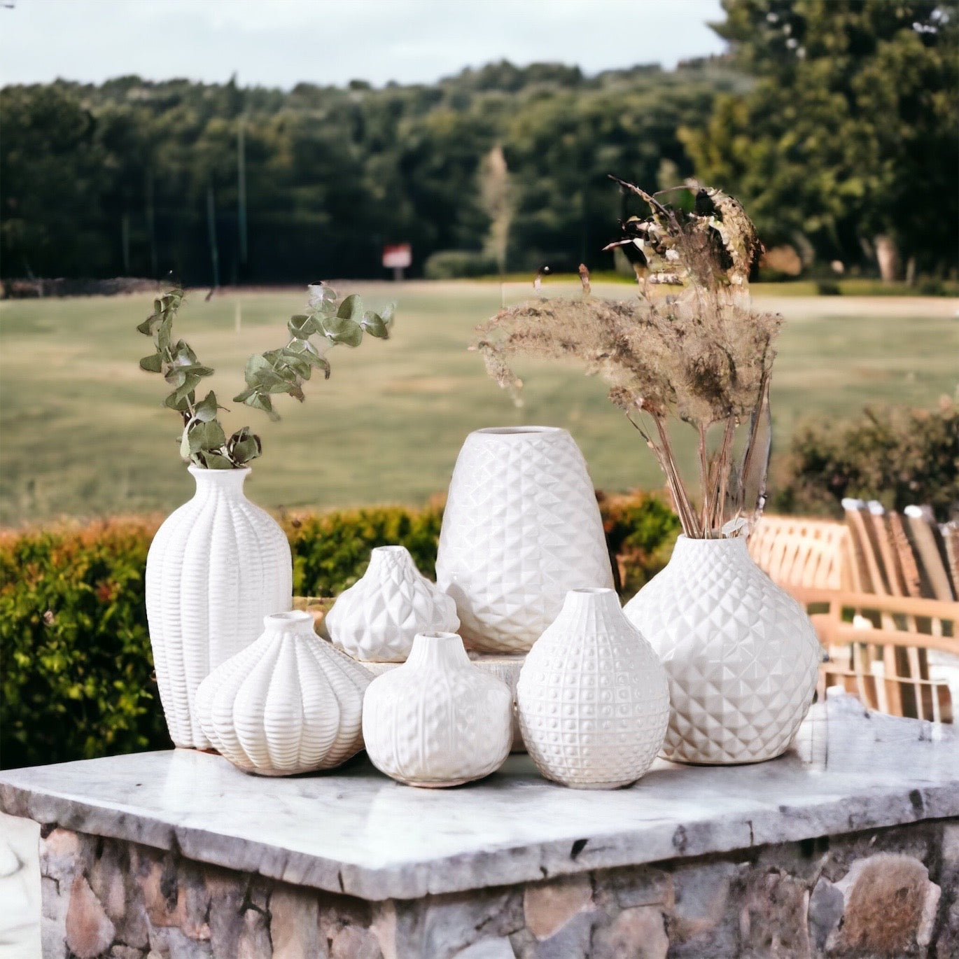 Elegant white ceramic Whitney Vases, artisan-made with exquisite detailing, perfect for flowers or home decor.