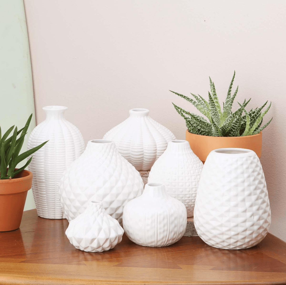 Elegant white ceramic Whitney Vases, artisan-made with exquisite detailing, perfect for flowers or home decor.