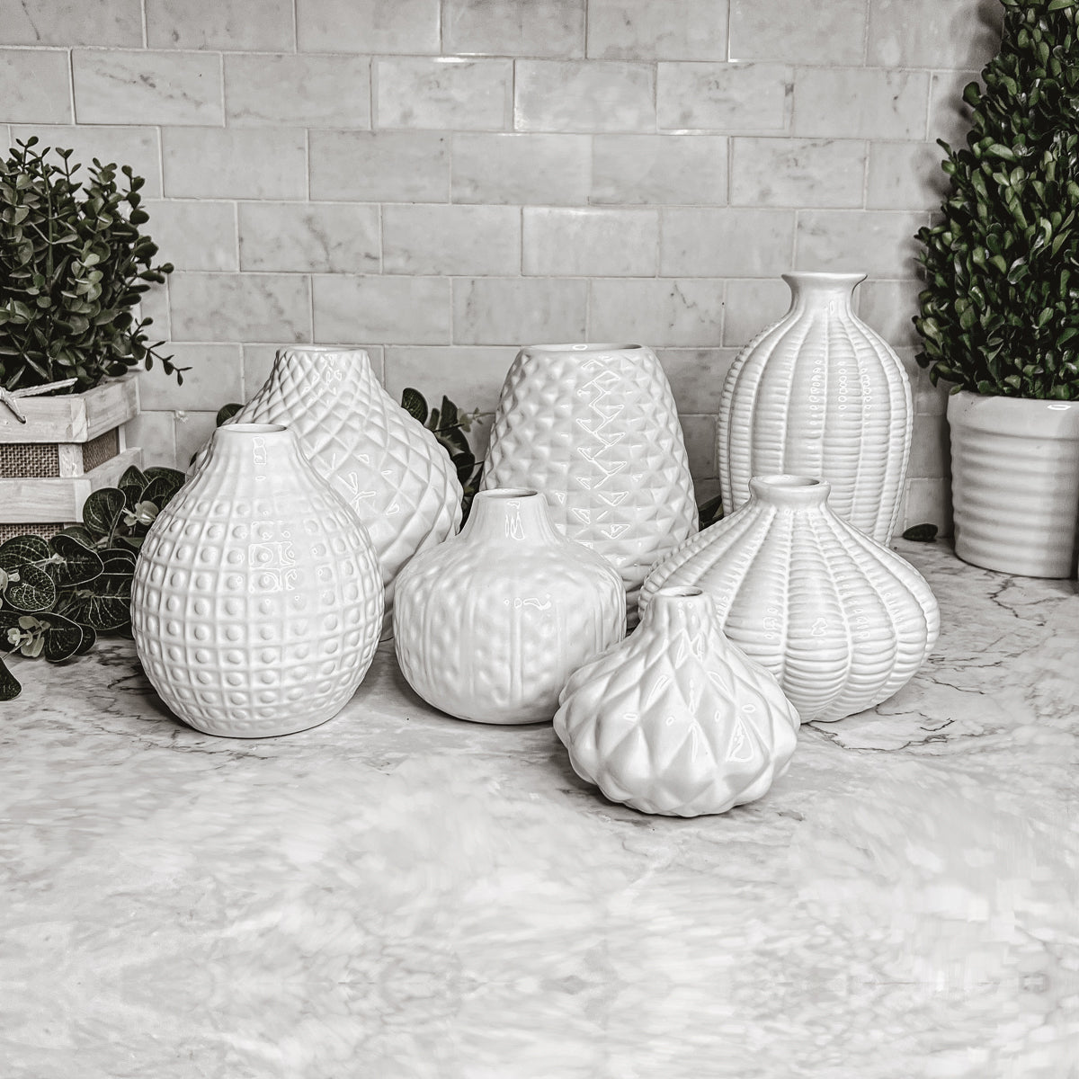 Elegant white ceramic Whitney Vases, artisan-made with exquisite detailing, perfect for flowers or home decor.