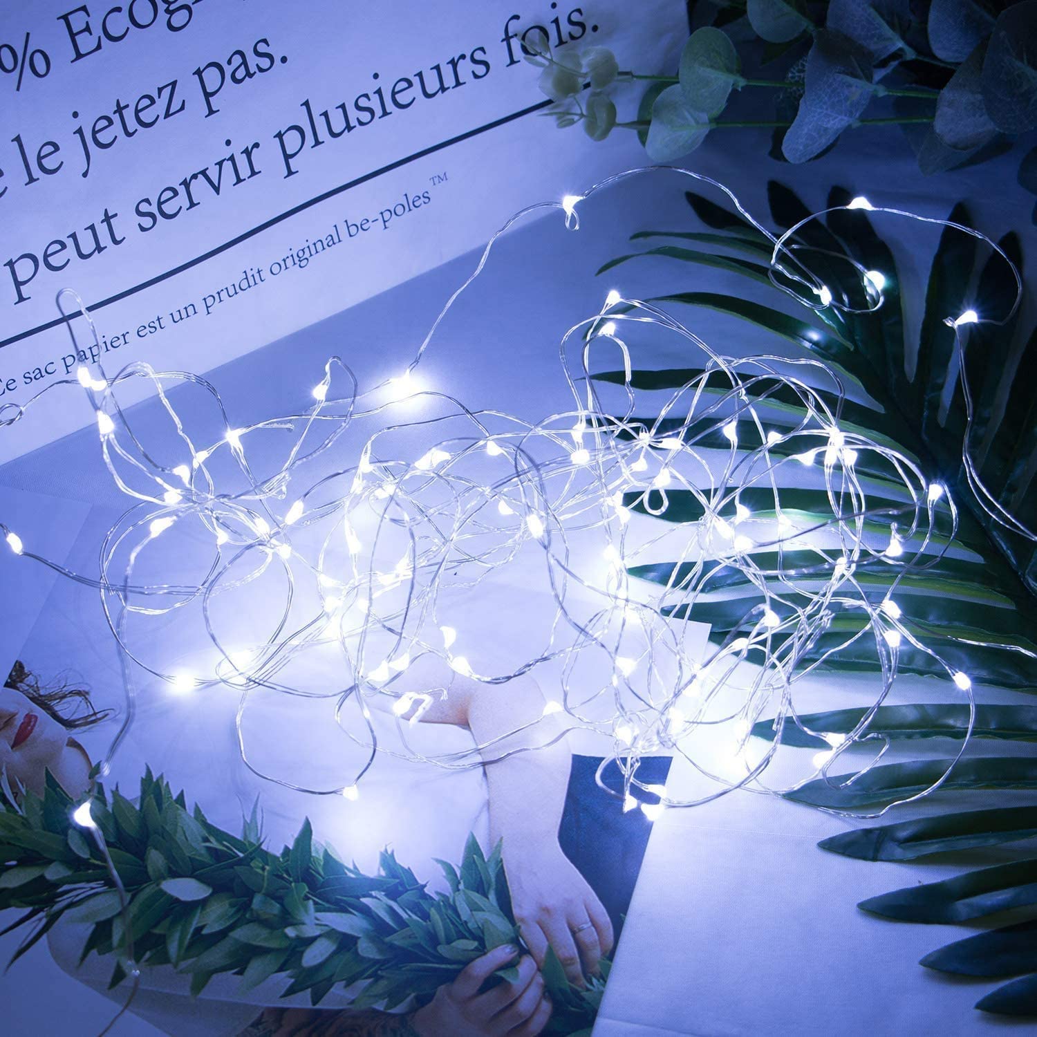 A beautiful display of 12 pack CR2032 Firefly Starry Lights on a silver wire, showcasing warm white LED lights perfect for decoration.