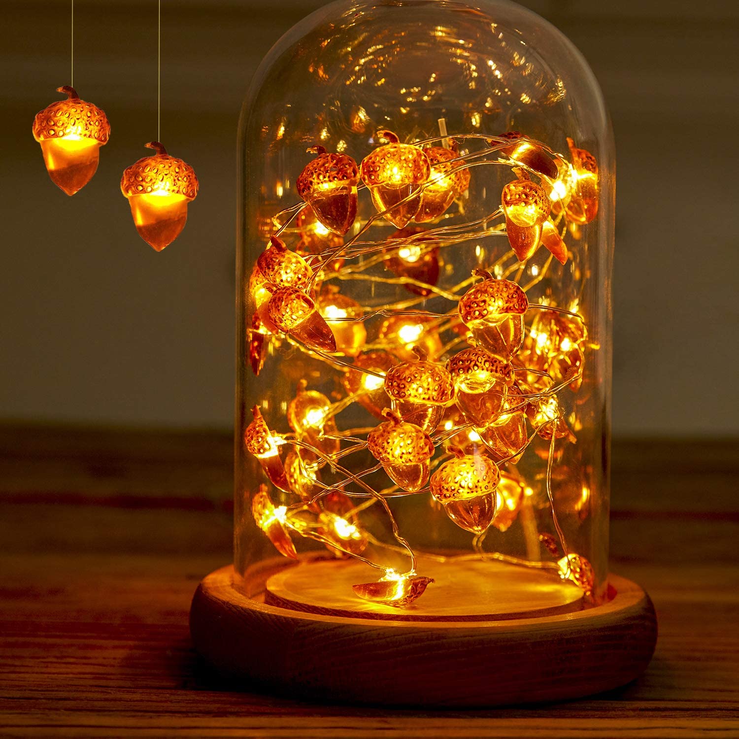 A string of battery-powered acorn-shaped LED lights, perfect for Thanksgiving and autumn decorations, showcasing a warm glow against a cozy backdrop.