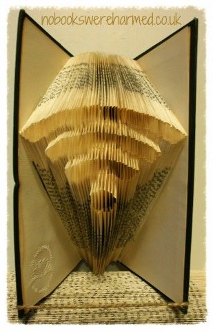 Handcrafted wifi symbol art made from vintage book pages, showcasing intricate folds and unique textures.