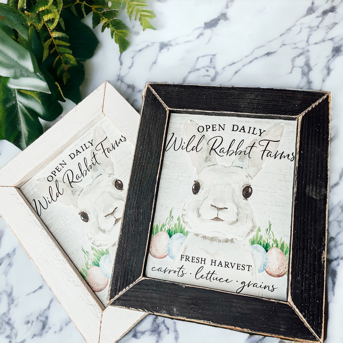 Wild Rabbit Farms Easter sign featuring a rustic design with pastel eggs and a hand-painted wooden frame.