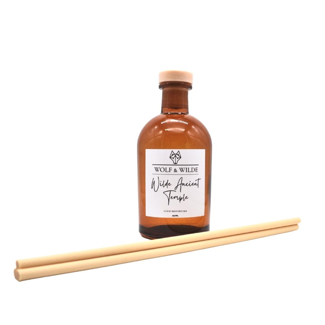 Wilde Ancient Temple Apothecary Reed Diffuser in amber bottle with natural reeds, showcasing its elegant design and eco-friendly materials.