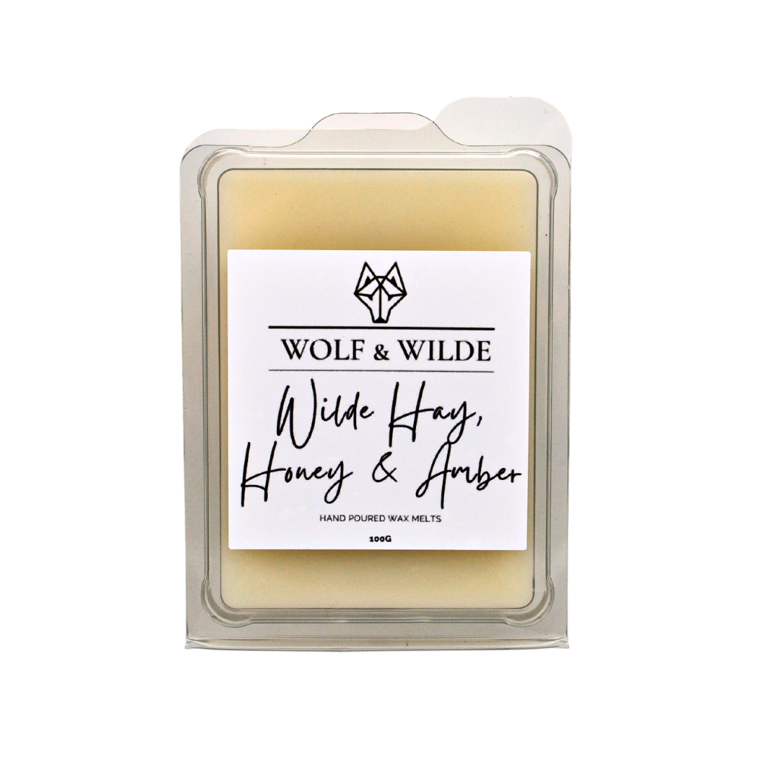 Wilde Hay, Honey & Amber Soy Wax Melts in a decorative package, showcasing the rich colors and textures of the melts.