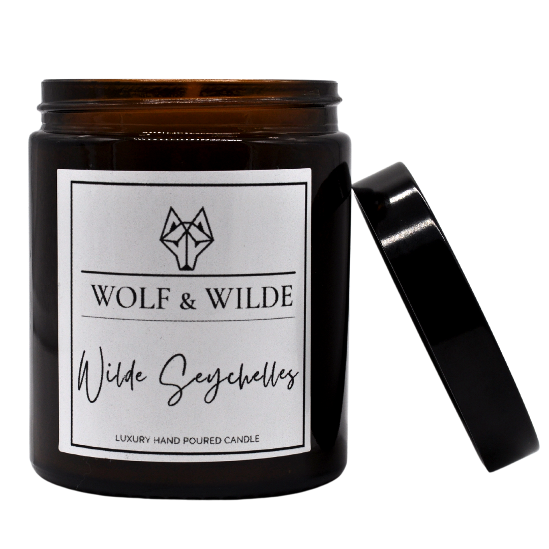 Wilde Seychelles Luxury Aromatherapy Scented Candle with exotic fragrance notes of bergamot, coconut, and vanilla in an elegant jar.