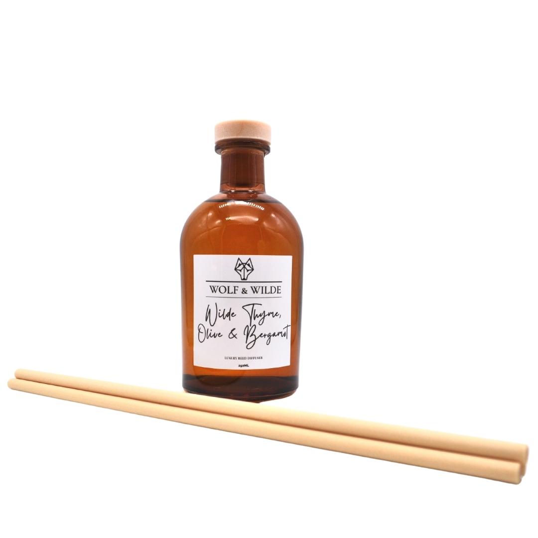 Wilde Thyme, Olive & Bergamot Apothecary Reed Diffuser in an amber bottle with natural reeds, showcasing its elegant design and eco-friendly materials.