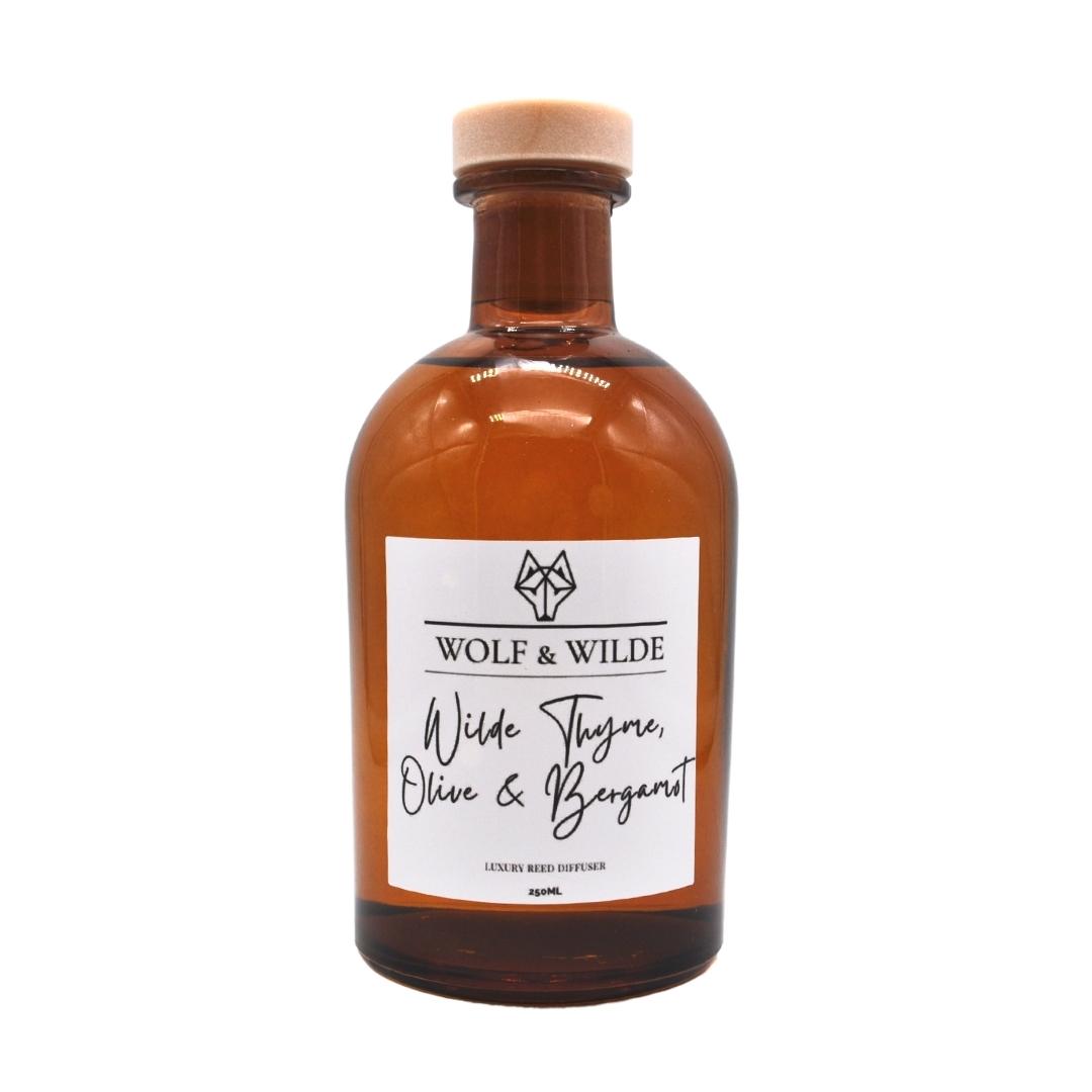 Wilde Thyme, Olive & Bergamot Apothecary Reed Diffuser in an amber bottle with natural reeds, showcasing its elegant design and eco-friendly materials.