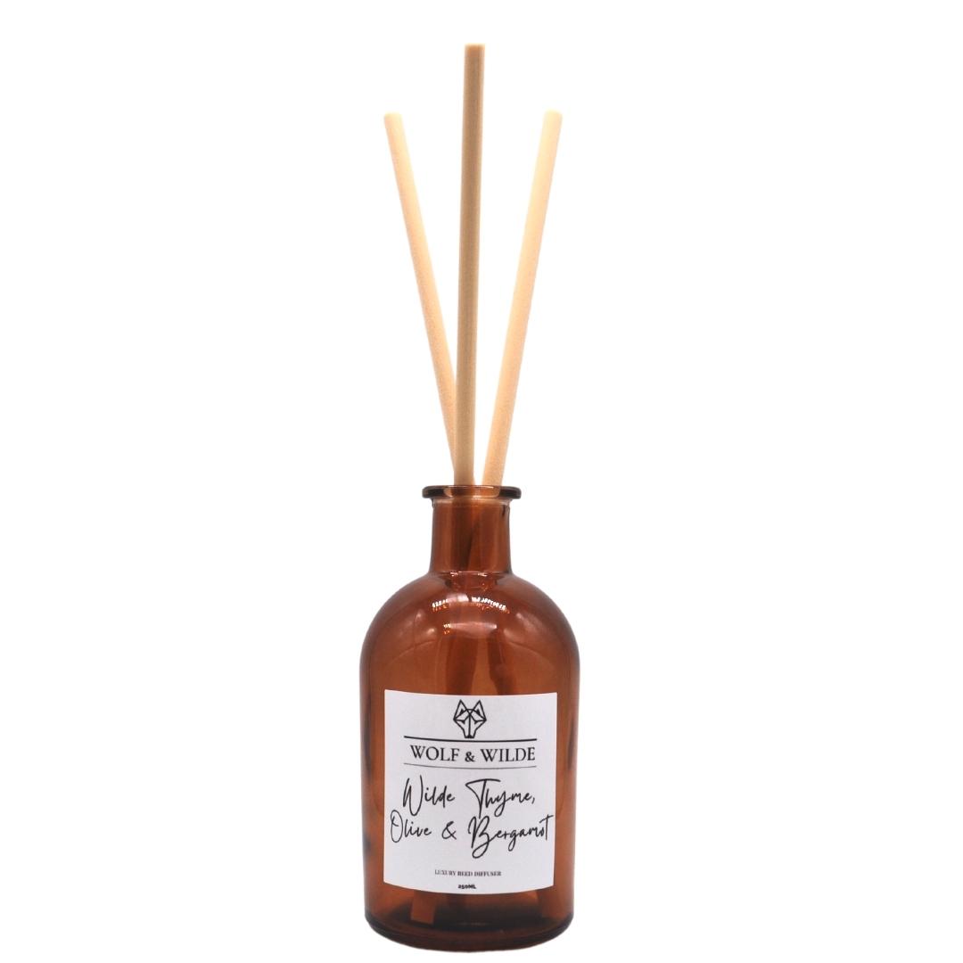 Wilde Thyme, Olive & Bergamot Apothecary Reed Diffuser in an amber bottle with natural reeds, showcasing its elegant design and eco-friendly materials.