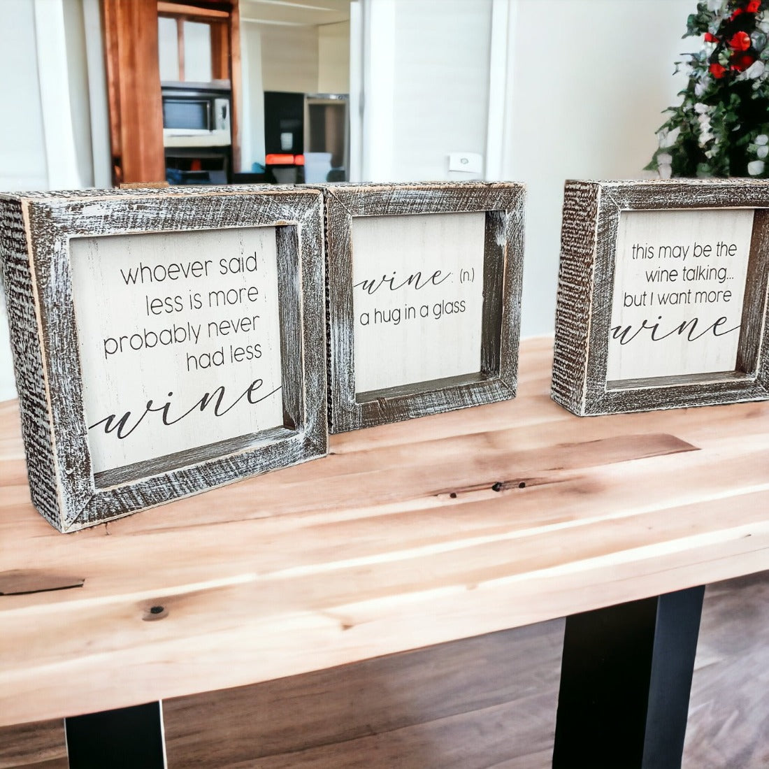 A beautifully framed wooden sign that reads 'Wine: A Hug', featuring a white-washed finish, perfect for home decor.