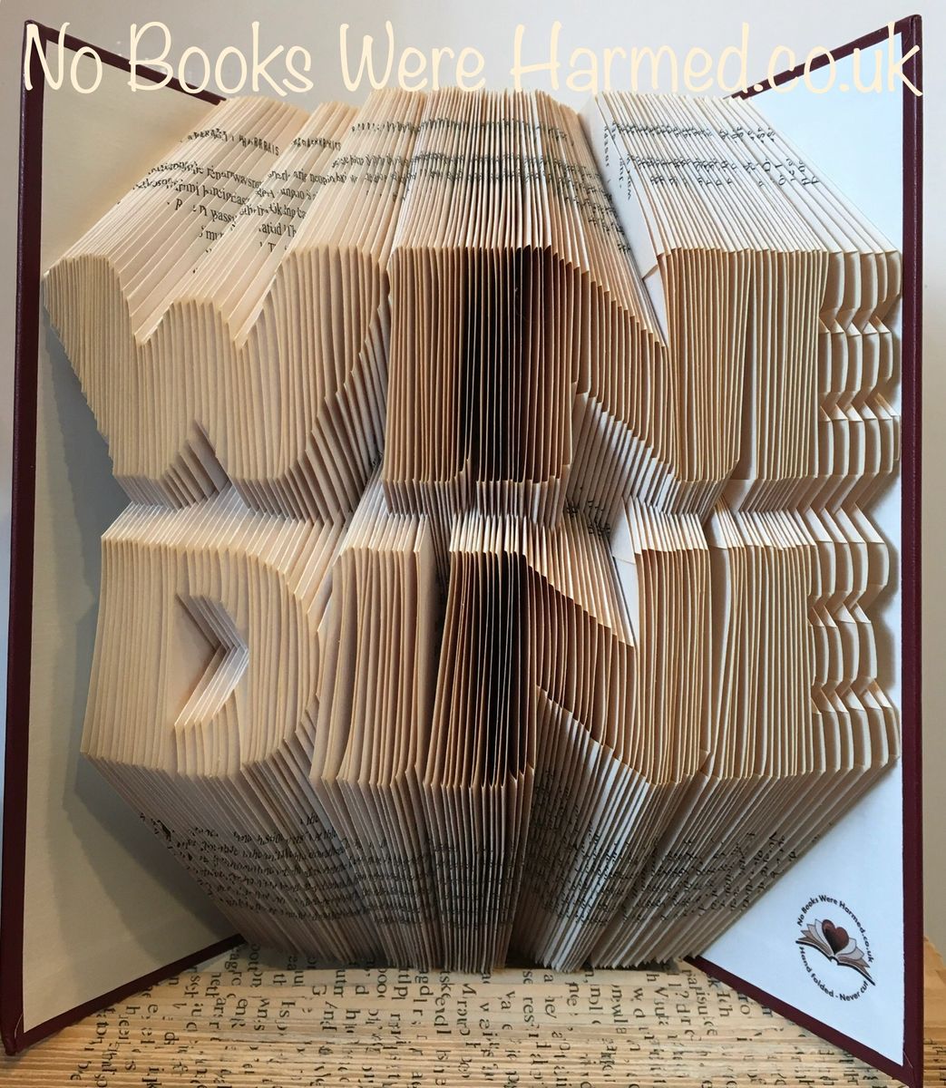 Handcrafted WINE DINE book art made from vintage books, showcasing intricate page folds and unique design.