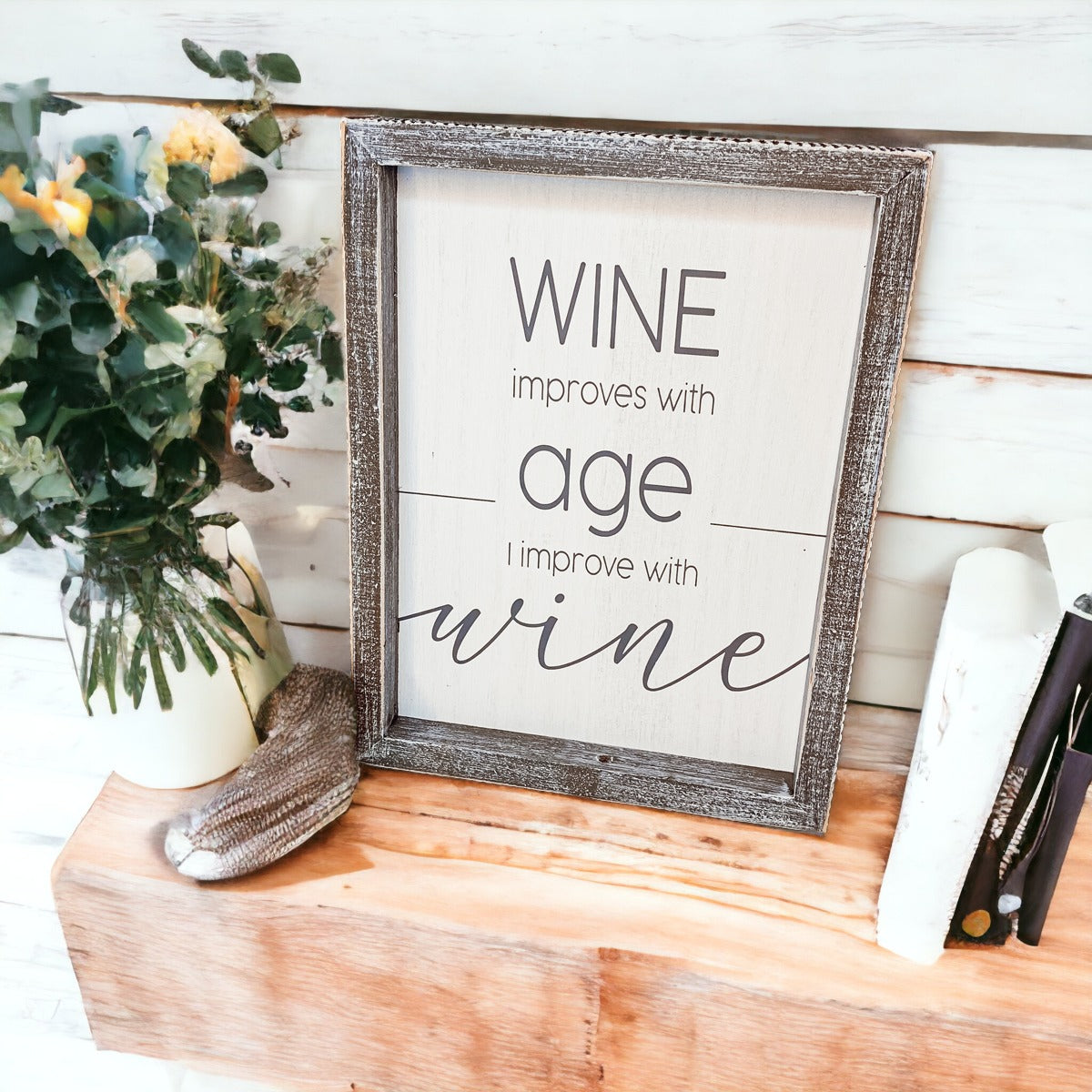 A stylish wood sign that reads 'Wine improves with age, I improve with wine', featuring a modern design in white and grey colors.