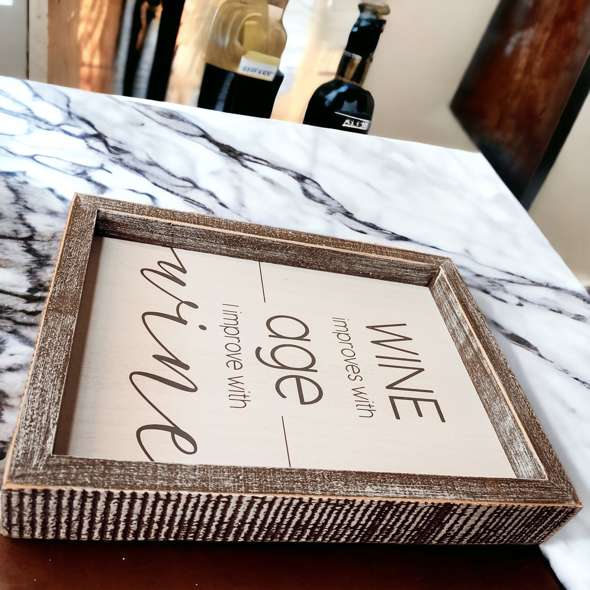 A stylish wood sign that reads 'Wine improves with age, I improve with wine', featuring a modern design in white and grey colors.