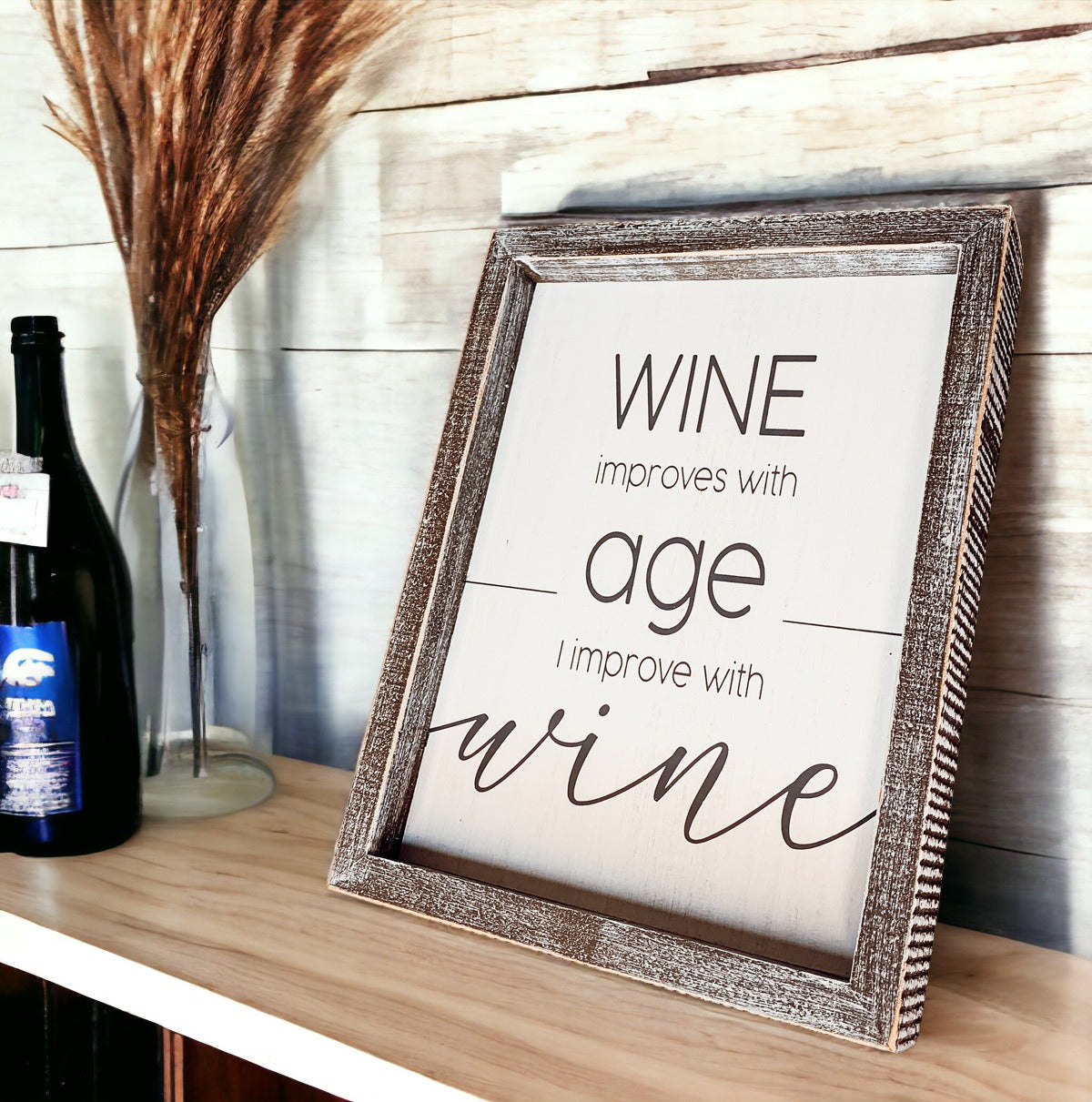 A stylish wood sign that reads 'Wine improves with age, I improve with wine', featuring a modern design in white and grey colors.