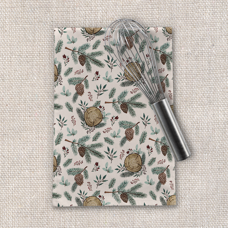 Winter-themed tea towel featuring branches, berries, and pine cones design, made from cotton twill, perfect for kitchen use.