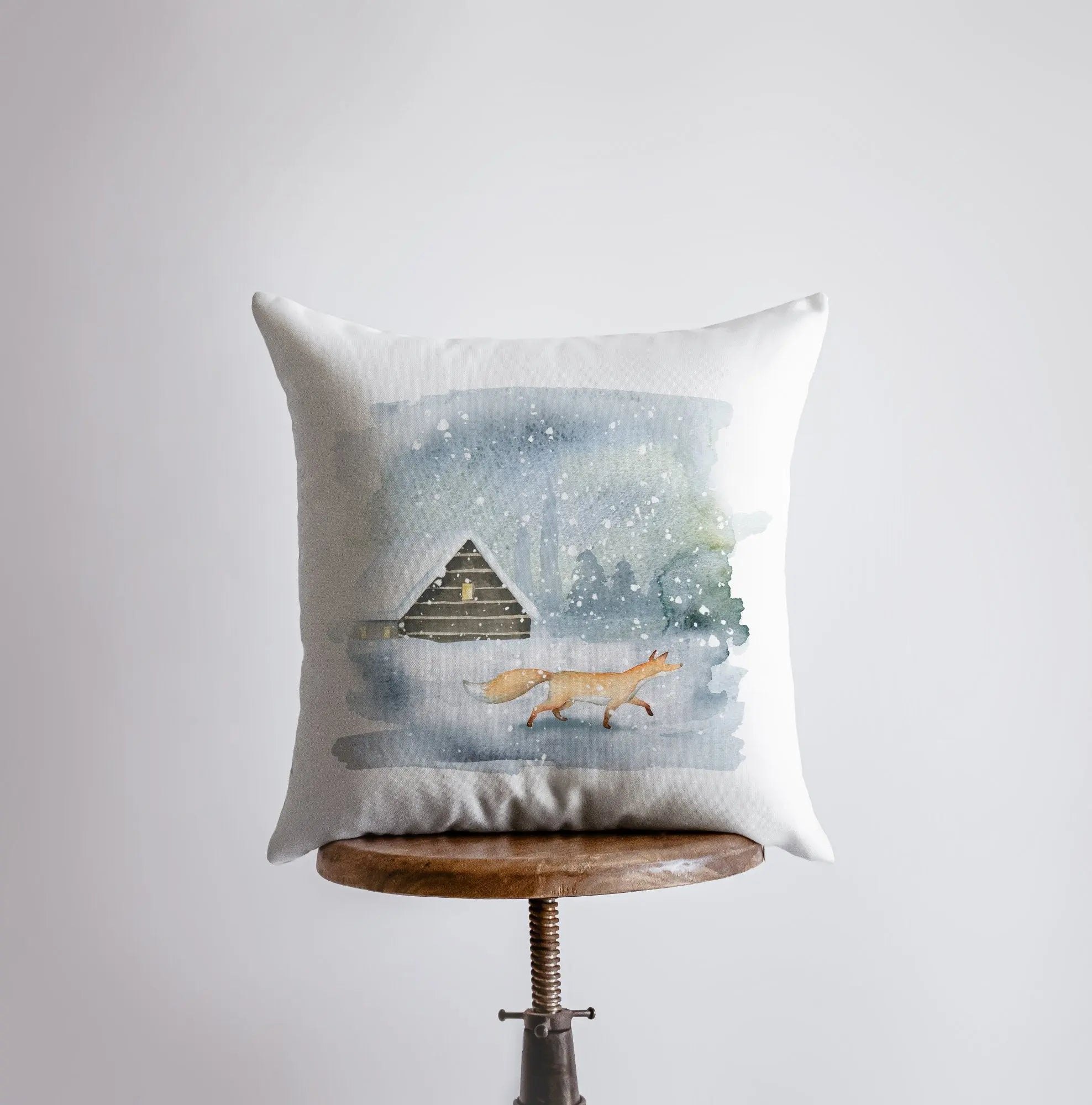 Winter Fox Scene Pillow Cover featuring a fox in snow with a cabin background, handmade in America.