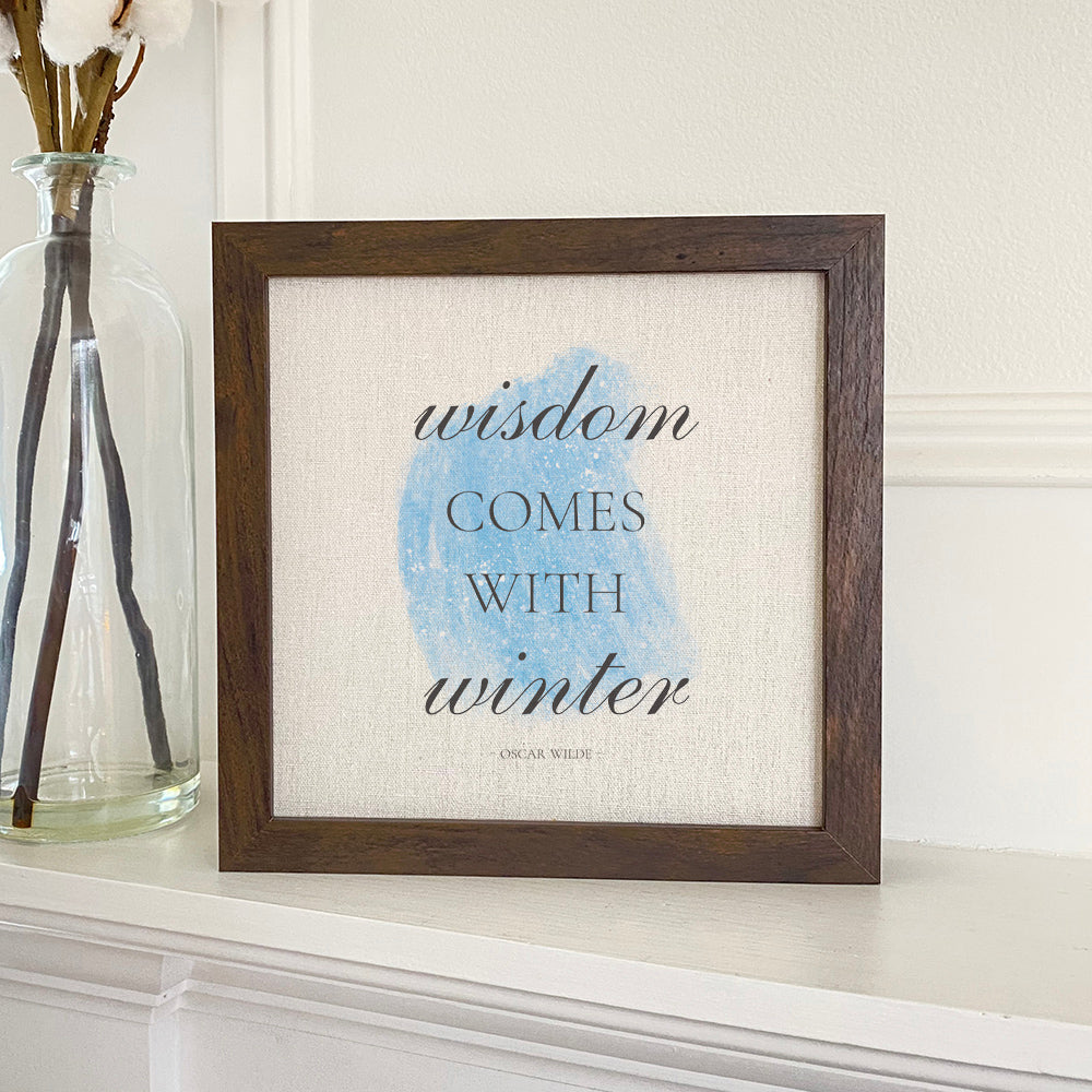 Winter Wisdom framed sign with a stylized wood frame, eco-friendly ink printing on a linen-look background, available in walnut or white-washed.