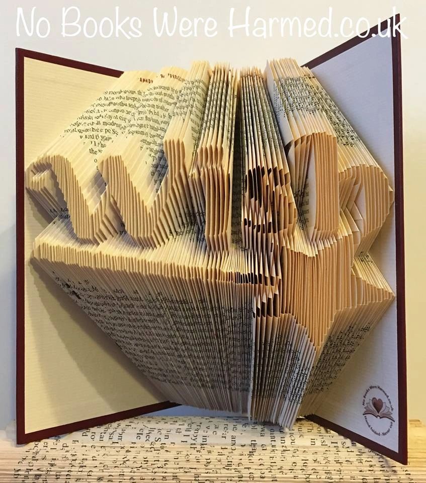 A unique hand-folded book art piece titled 'Wish' featuring a magic star wand, crafted from vintage book pages.