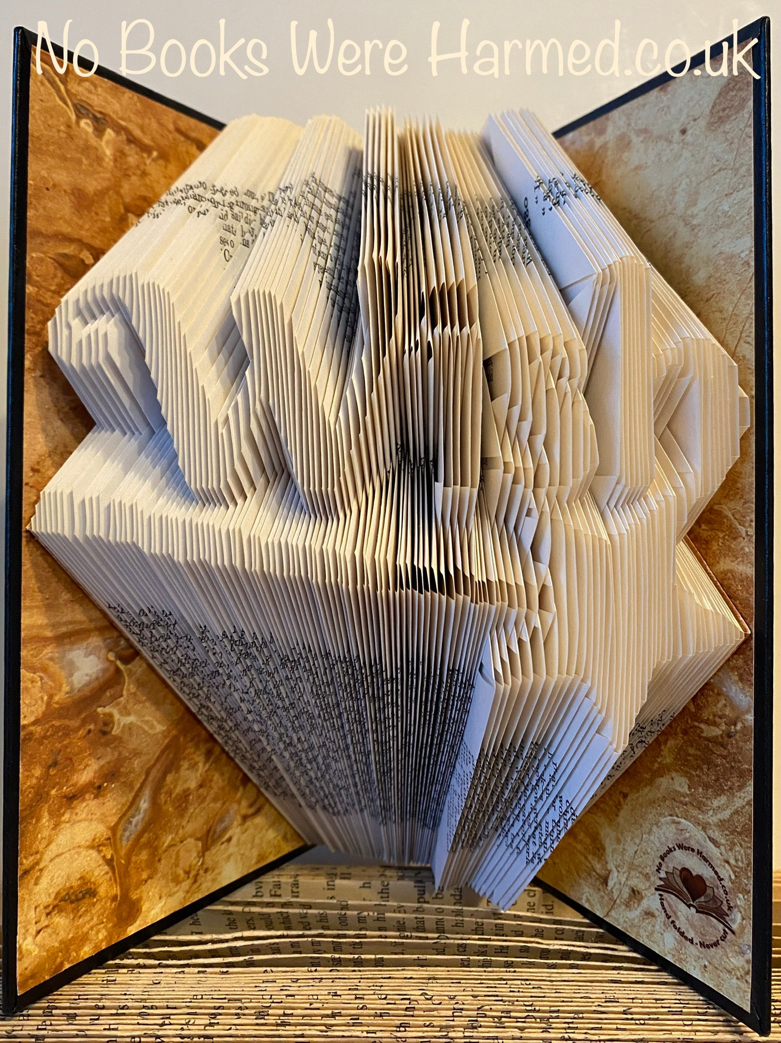 A unique hand-folded book art piece titled 'Wish' featuring a magic star wand, crafted from vintage book pages.