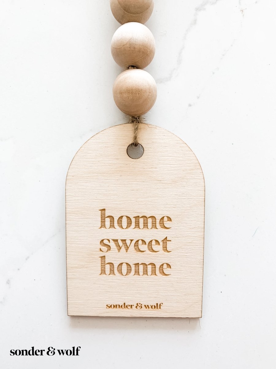 A beautifully crafted wooden charm, showcasing intricate laser-cut designs, perfect for home decor.