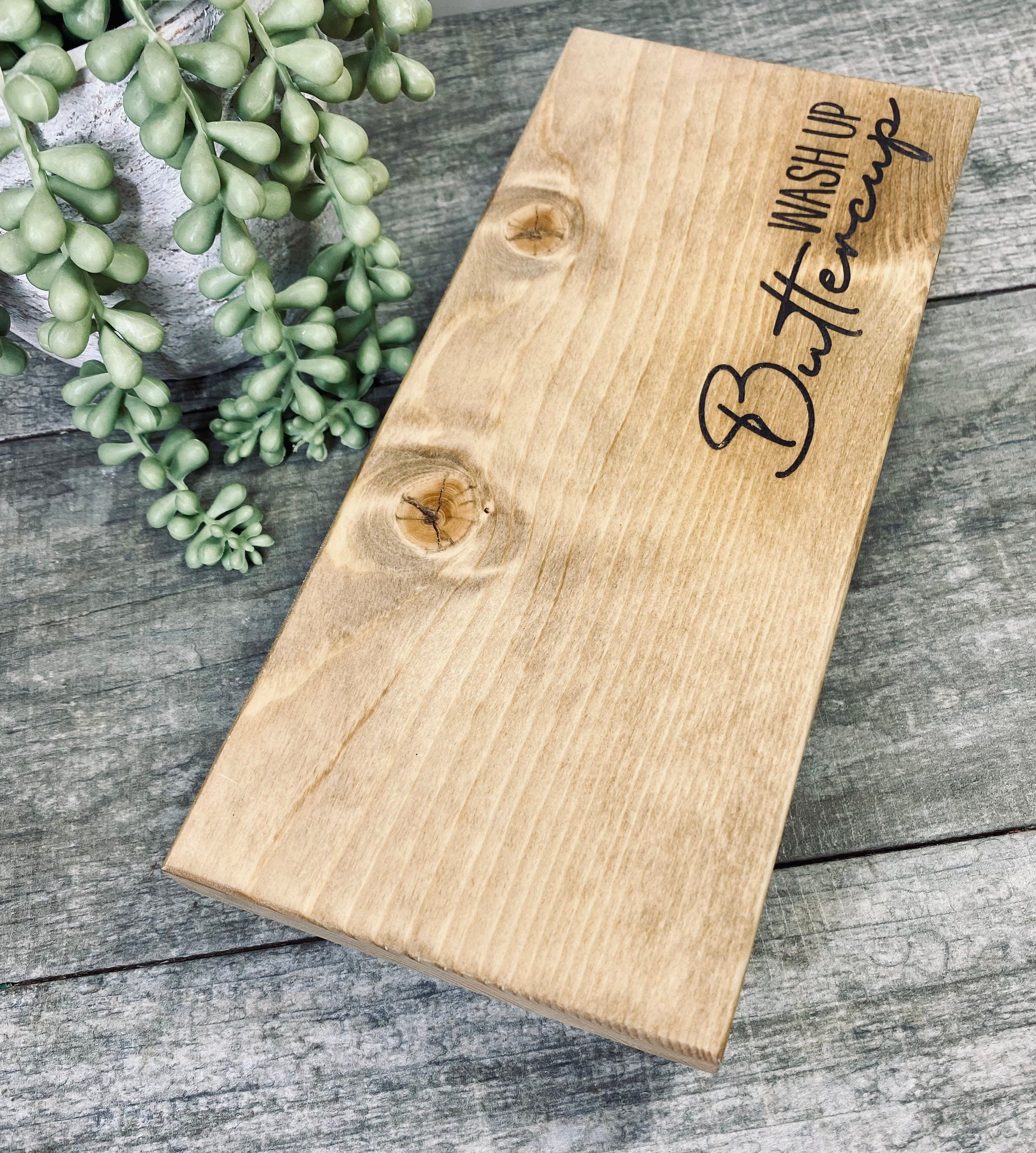 Handmade wooden riser with 'wash up buttercup' design, showcasing rustic charm and solid pine wood construction.