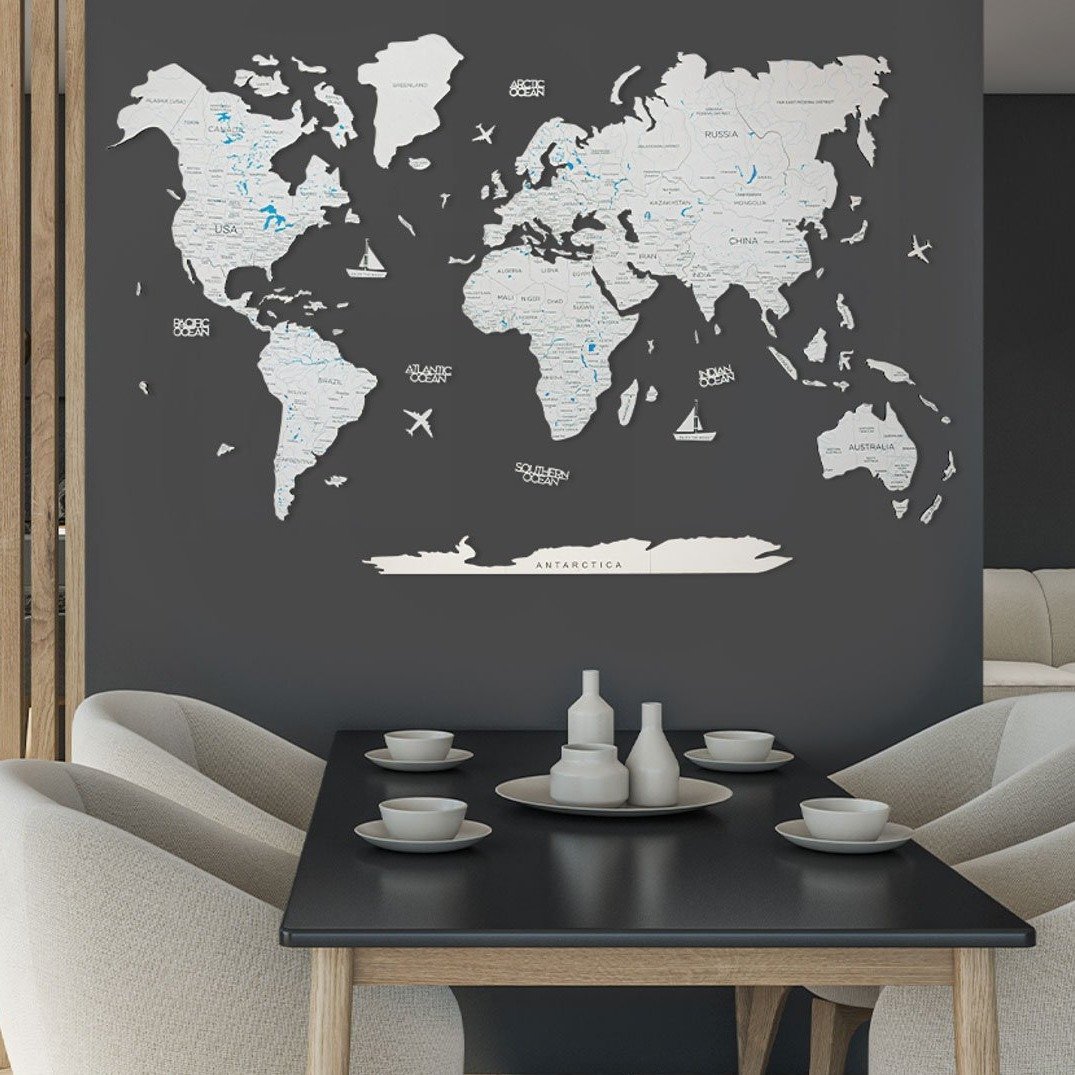 A beautifully crafted Wooden World Map in white, made from birch plywood, showcasing detailed geographical features and decorative elements.