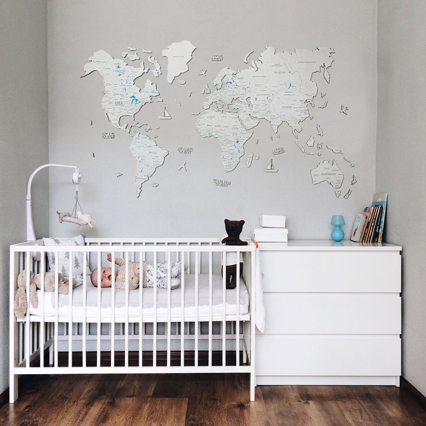 A beautifully crafted Wooden World Map in white, made from birch plywood, showcasing detailed geographical features and decorative elements.