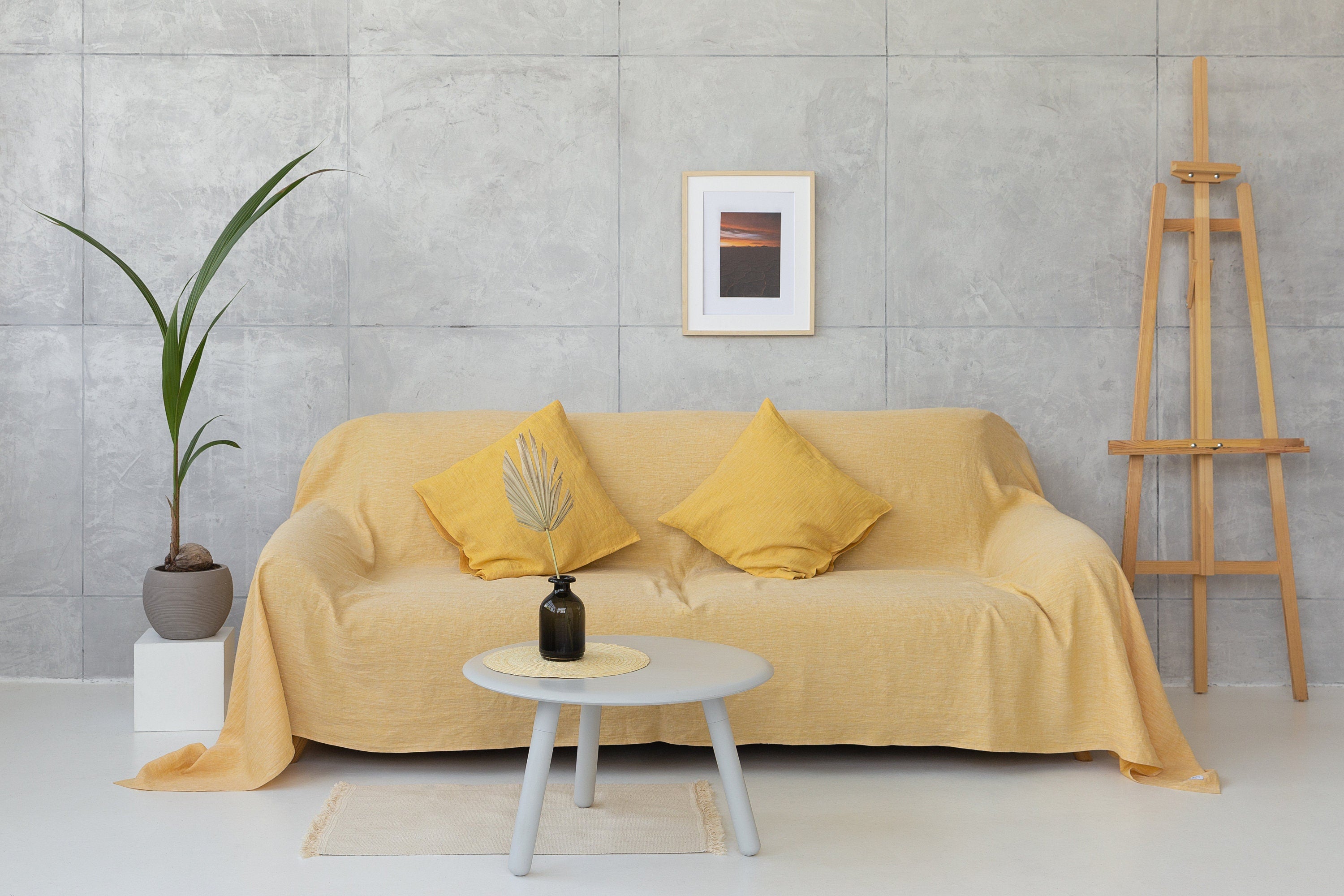 Woodrose linen couch cover draped elegantly over a sofa, showcasing its soft texture and natural color.