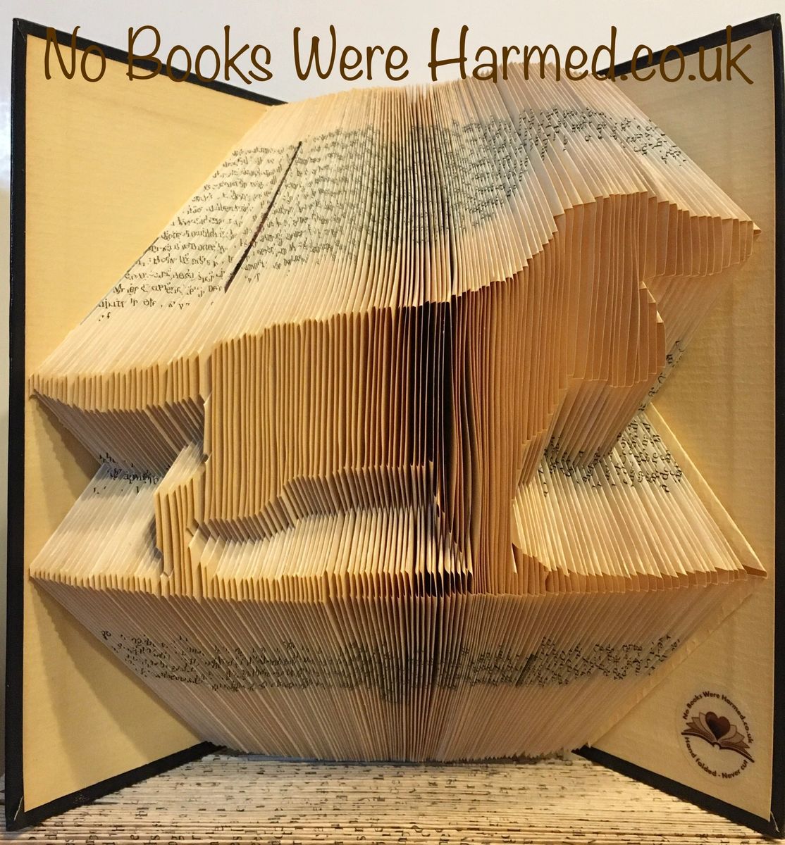 Handcrafted book art featuring working spaniels, cocker spaniels, and springer spaniels, made from vintage books with intricate folds.