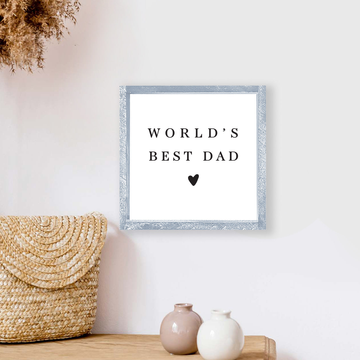 A beautifully crafted 8x8 inch wood sign that reads 'World's Best Dad', featuring a rustic pine wood frame and a white background.