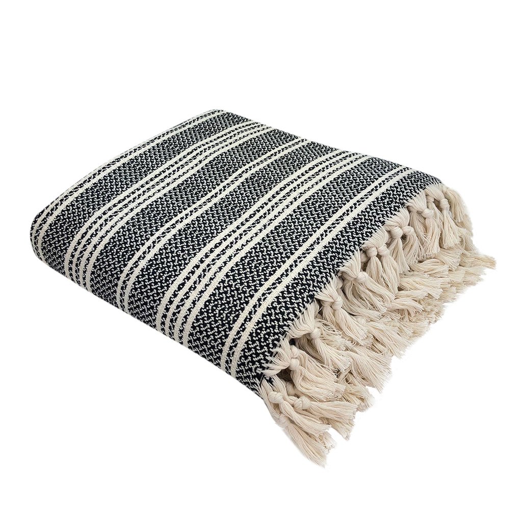 A cozy Woven Stripe Turkish Throw featuring intricate stripe patterns and hand-knotted fringe, perfect for home decor.