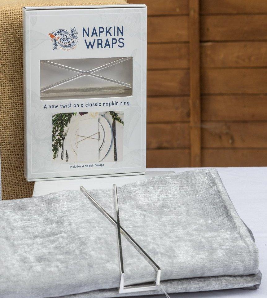 X Wrap Set of 4 shiny silver napkin wraps elegantly displayed in a stylish box.