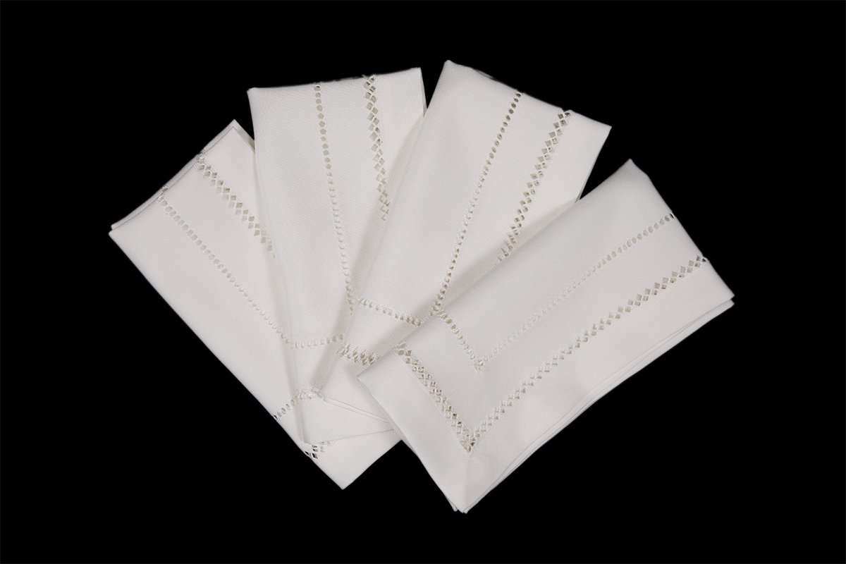 Set of 4 XD11099 Double Hemstitch Napkins in various colors, showcasing intricate hand-rendered cutwork trim.