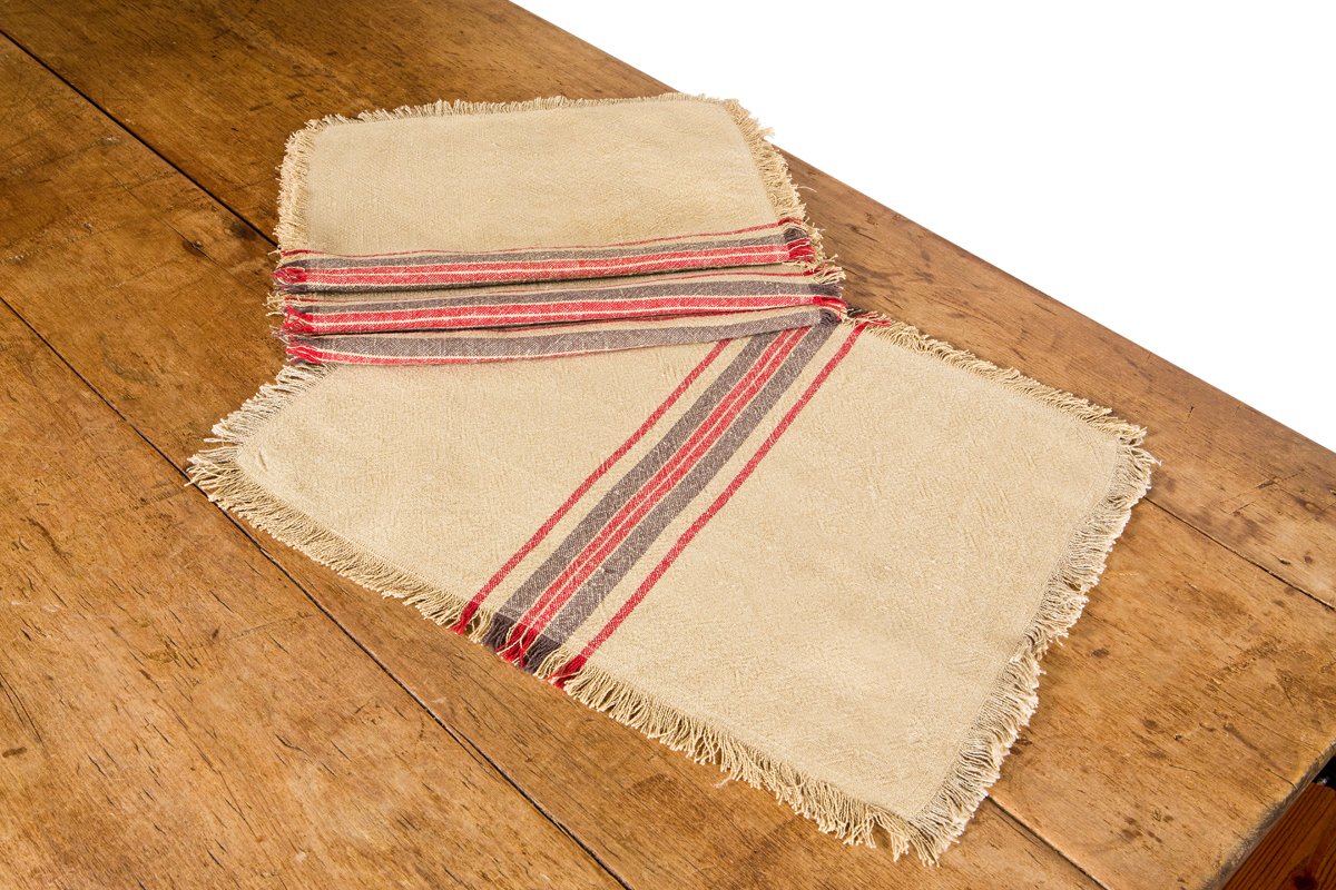 Set of 4 XD15008 Natural Linen Stripe Placemats with a rustic striped pattern and frayed edges, perfect for enhancing dining experiences.