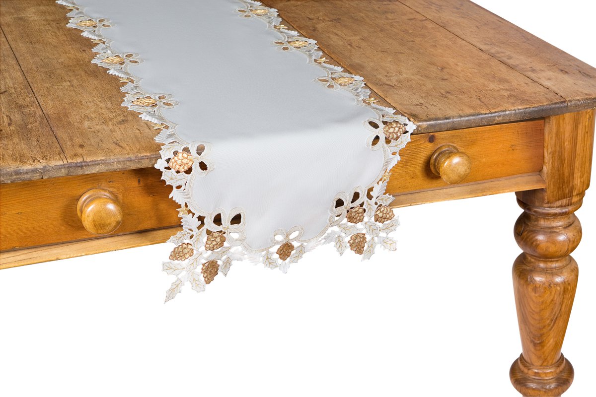 XD15807 Gilded Pines Table Runner featuring golden pinecone embroidery and scalloped edges on a muted background.