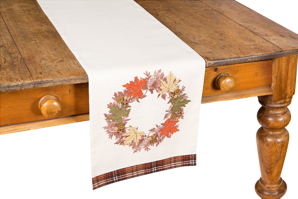 XD15833 Maple Wreath Table Runner featuring textured harvest design with cut-out leaves and button accents, adorned with autumnal tartan check trim.