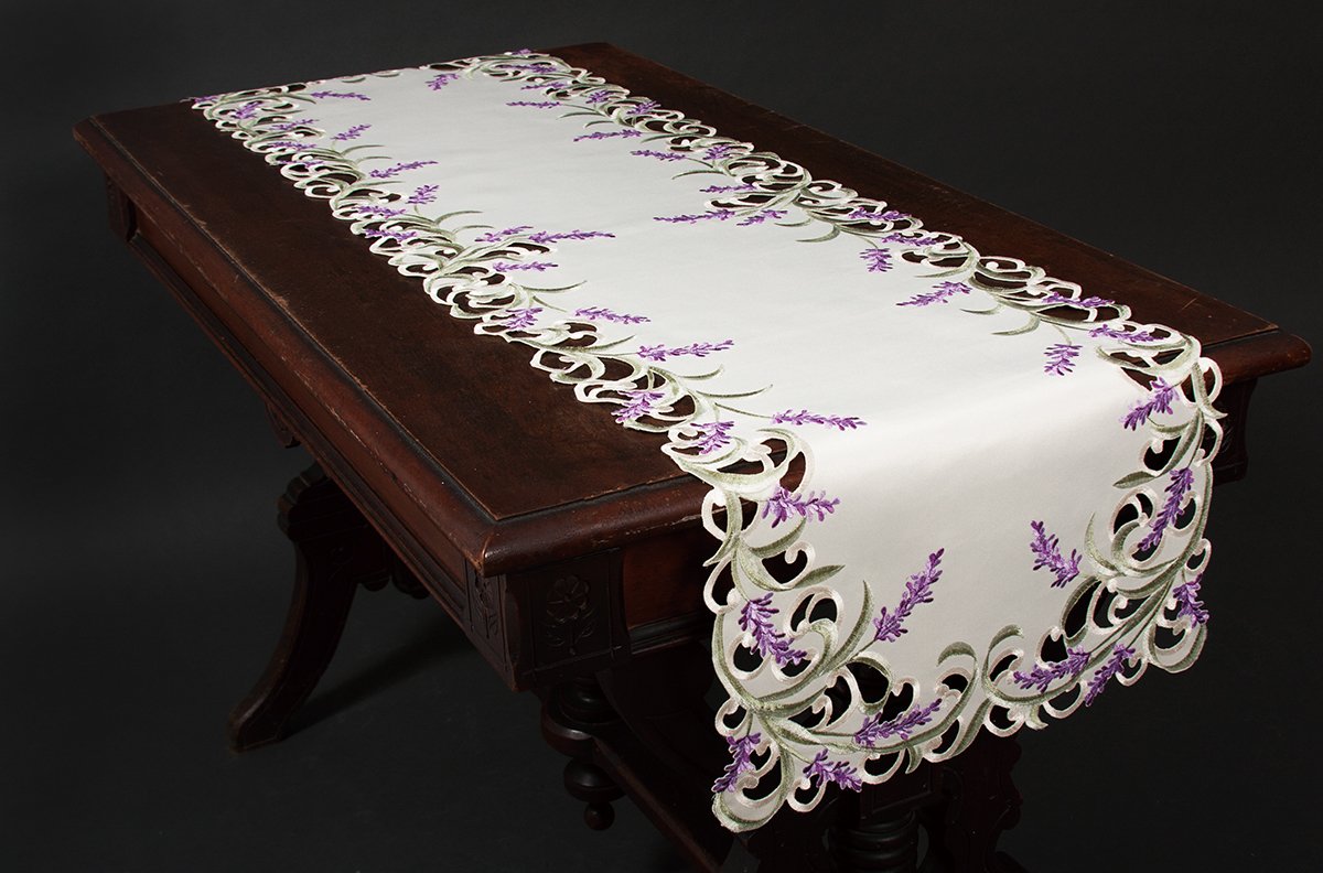 Elegant lavender lace table runner with scalloped edges and green embroidery, perfect for enhancing table settings.