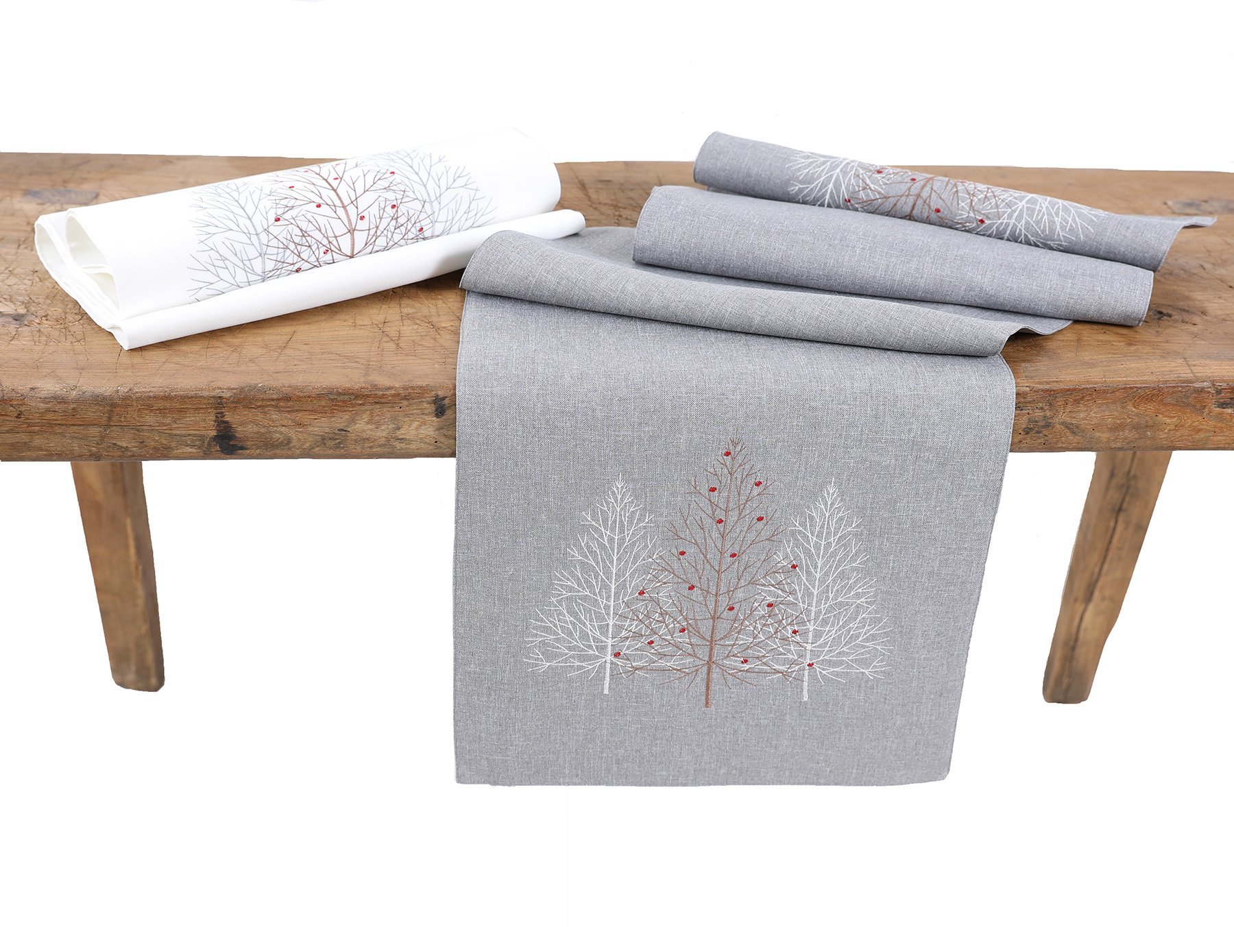 XD19803 Festive Trees Embroidered Christmas Table Runner featuring white Christmas trees and winter berries on a white background.