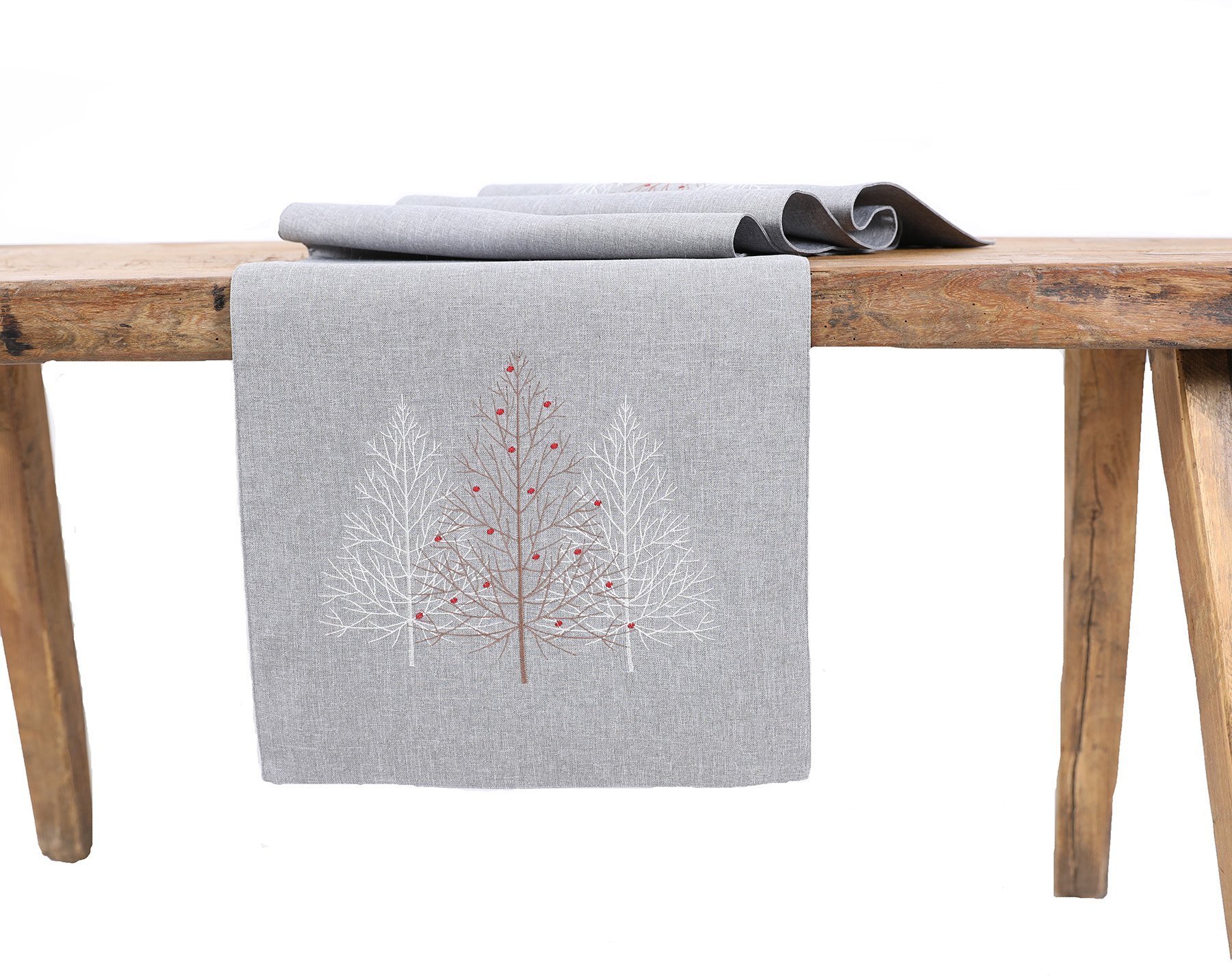 XD19803 Festive Trees Embroidered Christmas Table Runner featuring white Christmas trees and winter berries on a white background.