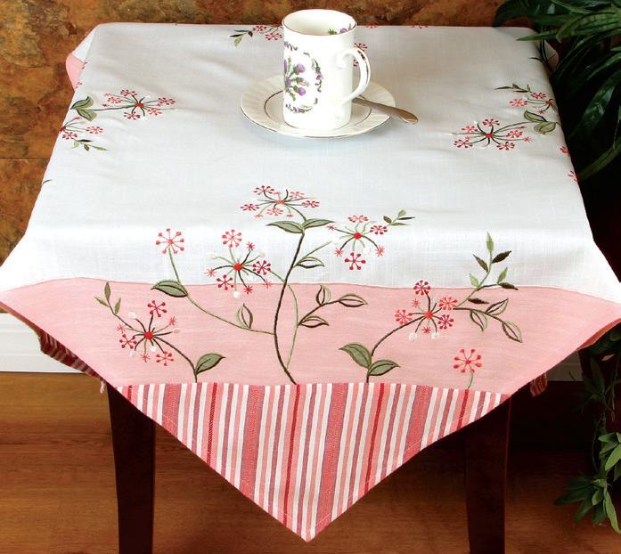 XD755002 Whimsy Collection table linens featuring cheerful floral embroidery and colorful stripes, perfect for spring and summer settings.