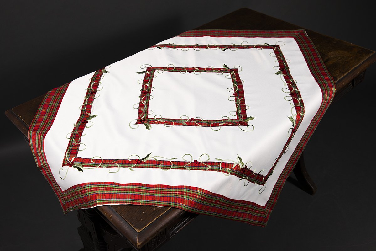 XD99904 Tartan Ribbon Table Topper featuring holly leaf embroidery and red/green plaid design, perfect for Christmas decor.