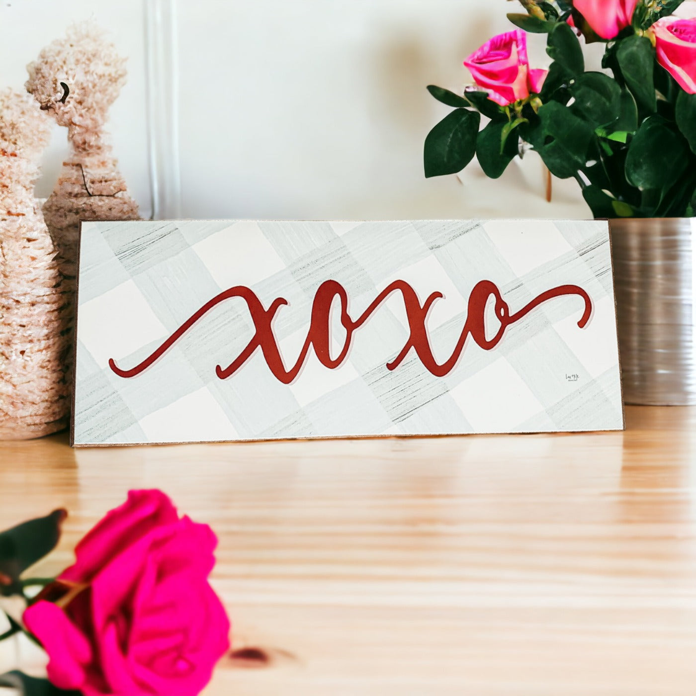 Handmade XOXO Sign made of thick wood with a light gray and white checkered background and darker red script, perfect for Valentine's Day decor.