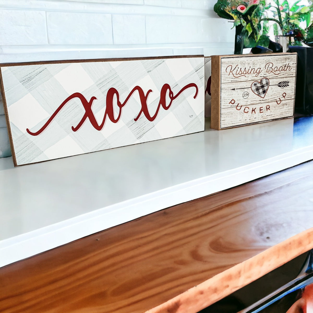 Handmade XOXO Sign made of thick wood with a light gray and white checkered background and darker red script, perfect for Valentine's Day decor.