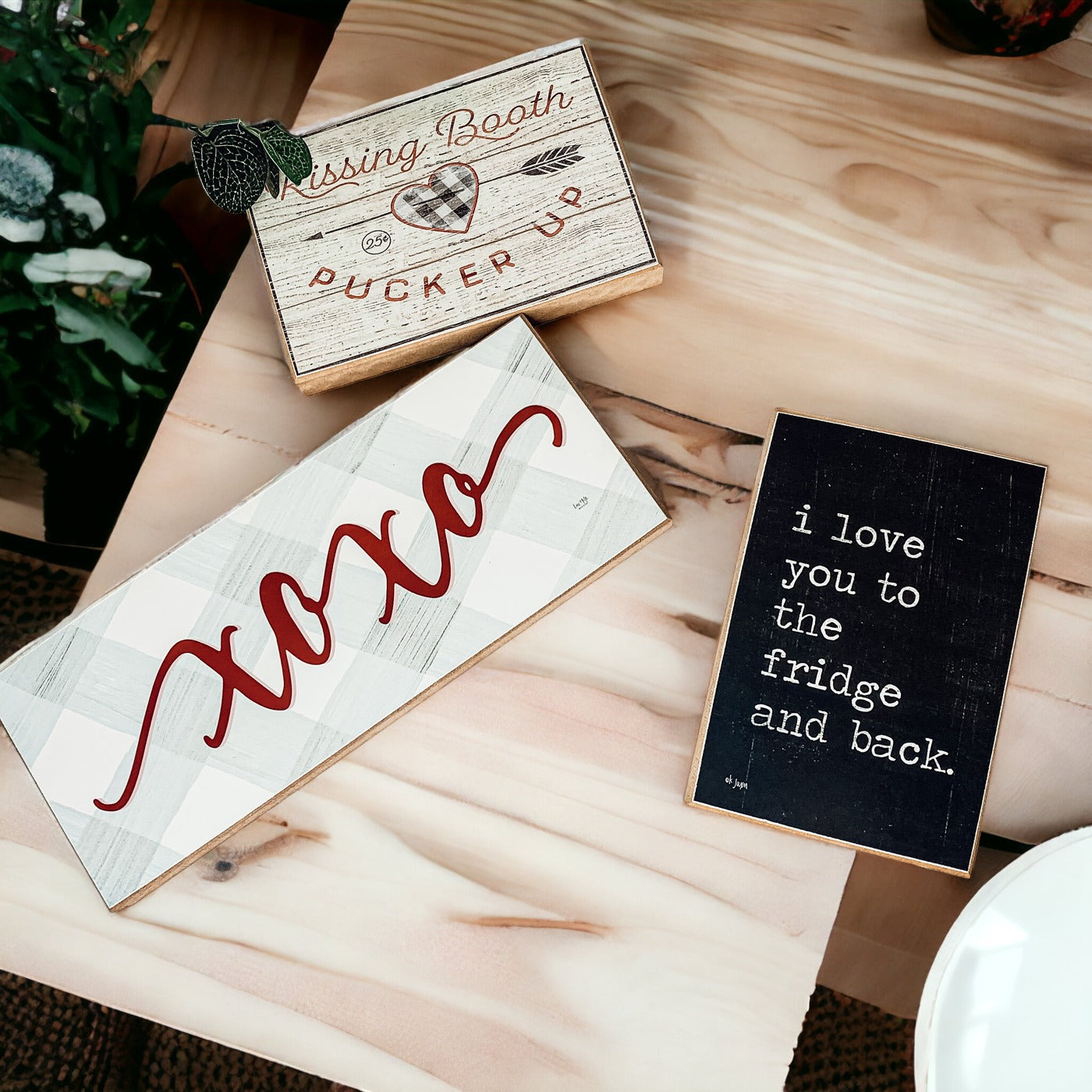 Handmade XOXO Sign made of thick wood with a light gray and white checkered background and darker red script, perfect for Valentine's Day decor.