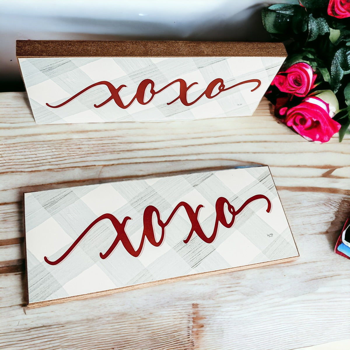 Handmade XOXO Sign made of thick wood with a light gray and white checkered background and darker red script, perfect for Valentine's Day decor.