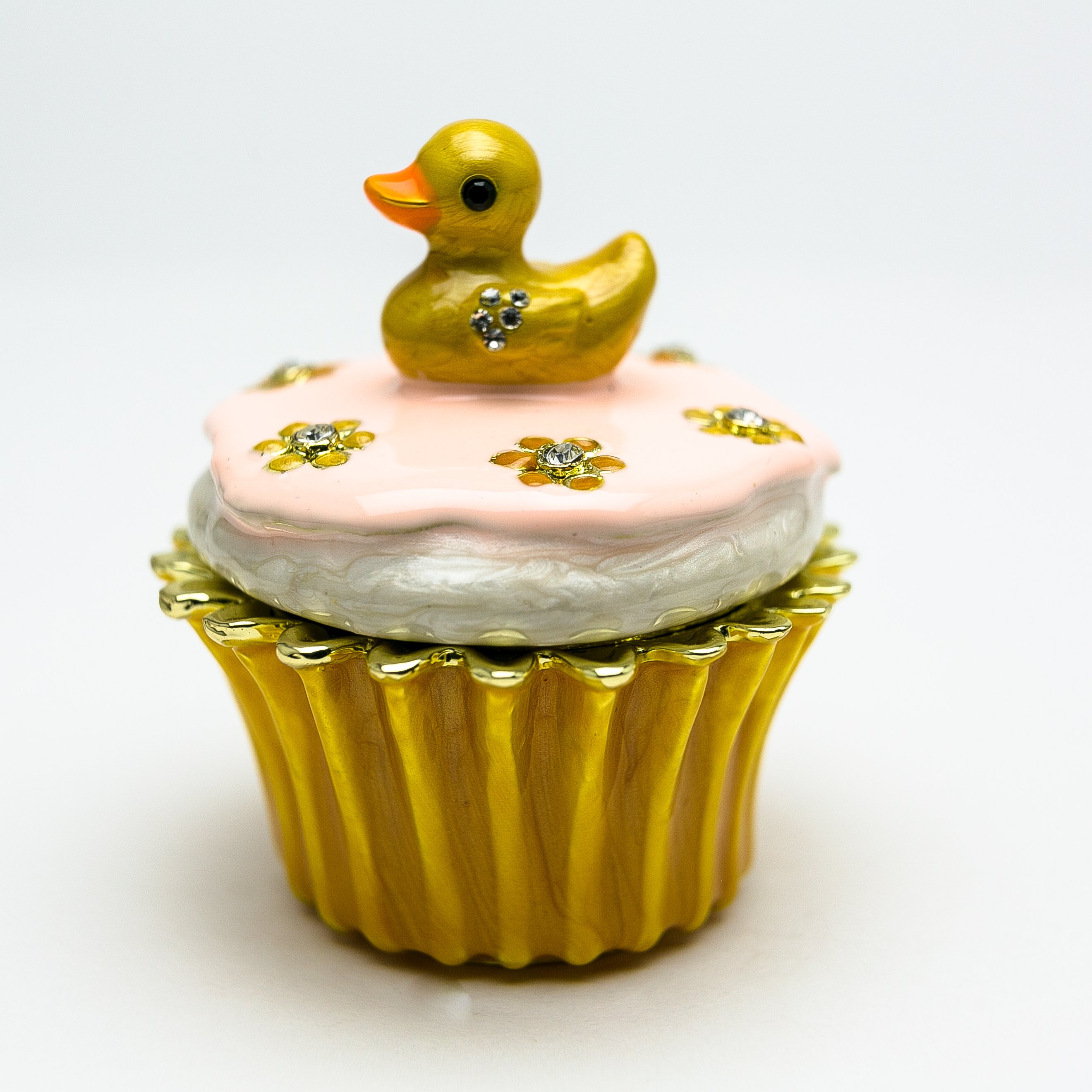 A beautifully handcrafted trinket box featuring a yellow duck on a cupcake, adorned with Austrian crystals and 24K gold plating.