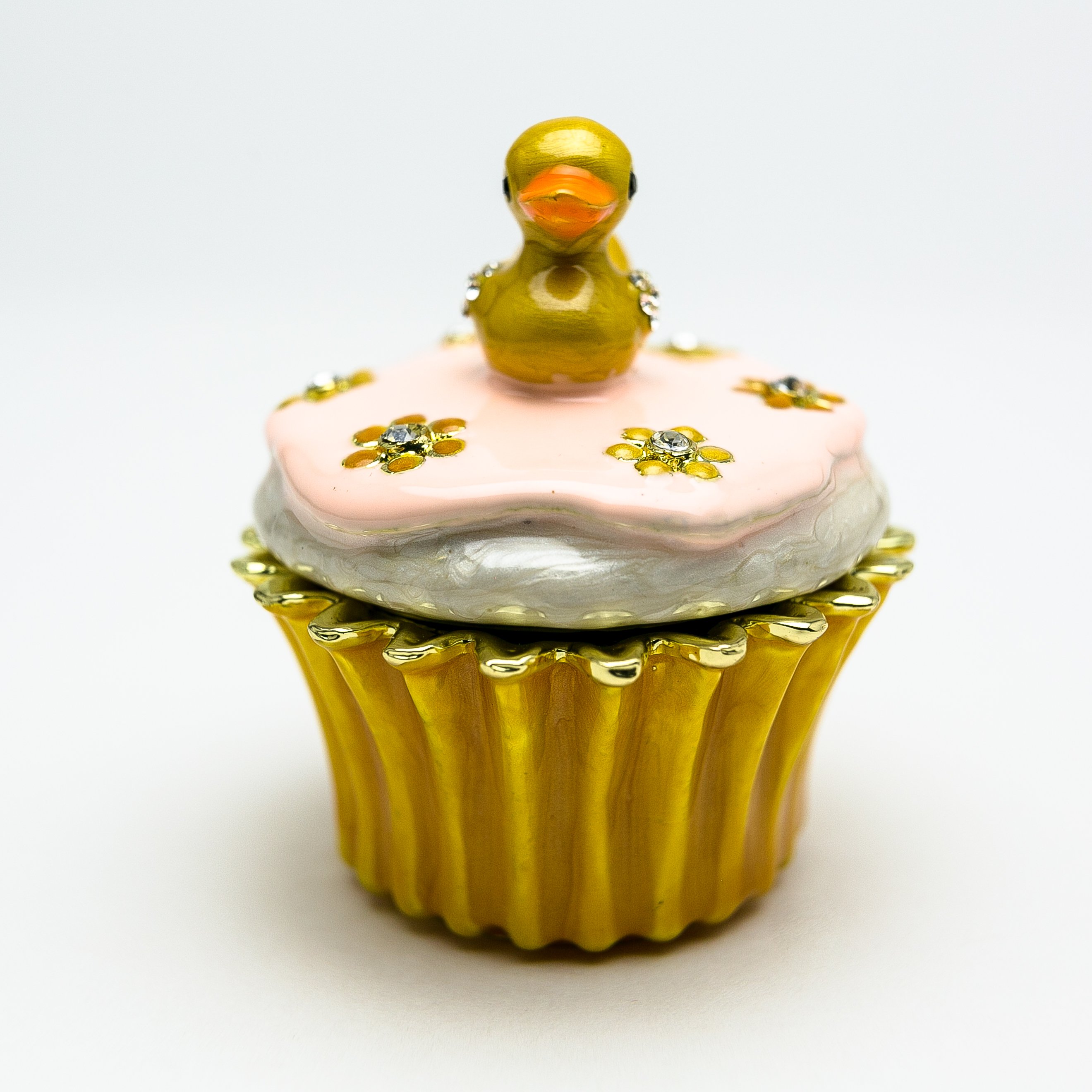 A beautifully handcrafted trinket box featuring a yellow duck on a cupcake, adorned with Austrian crystals and 24K gold plating.