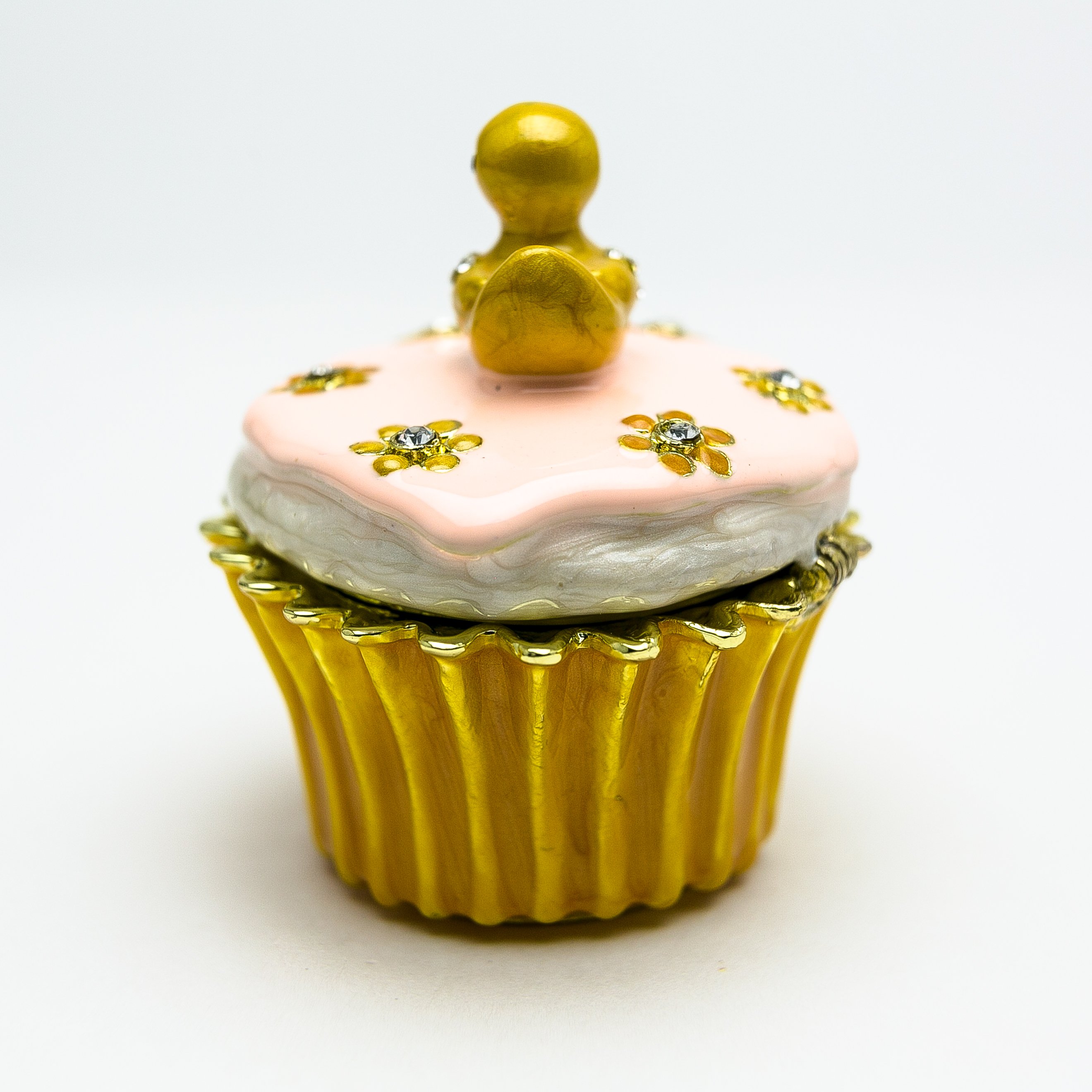 A beautifully handcrafted trinket box featuring a yellow duck on a cupcake, adorned with Austrian crystals and 24K gold plating.